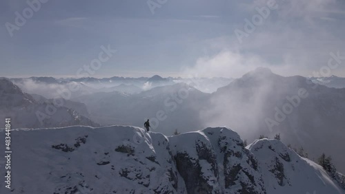 Trailrunner on Mountain Ridge in Alps Winter photo