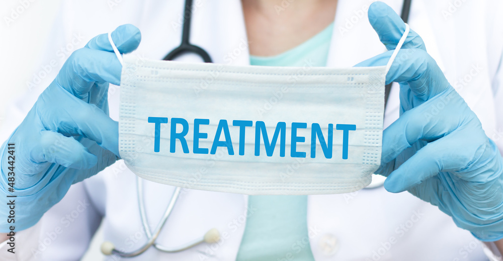 Treatment text on a protective mask in the hands of a doctor, a curl plan, a medical concept Treatment text on a protective mask in the hands of a doctor, a curl plan, a medical concept