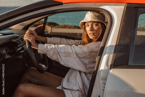 woman in a car on the beach in lagos algarve portugal 