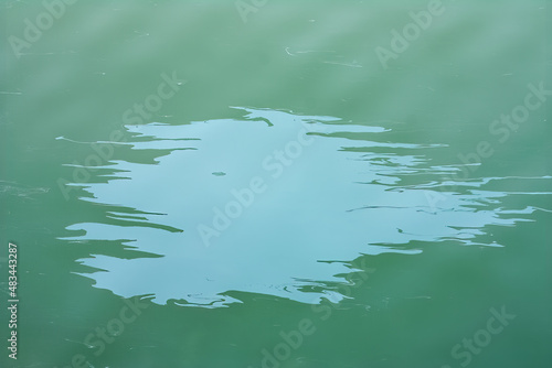 A large abstract stain from engine oil or gasoline spilled on the surface of the sea. Marble abstract background.