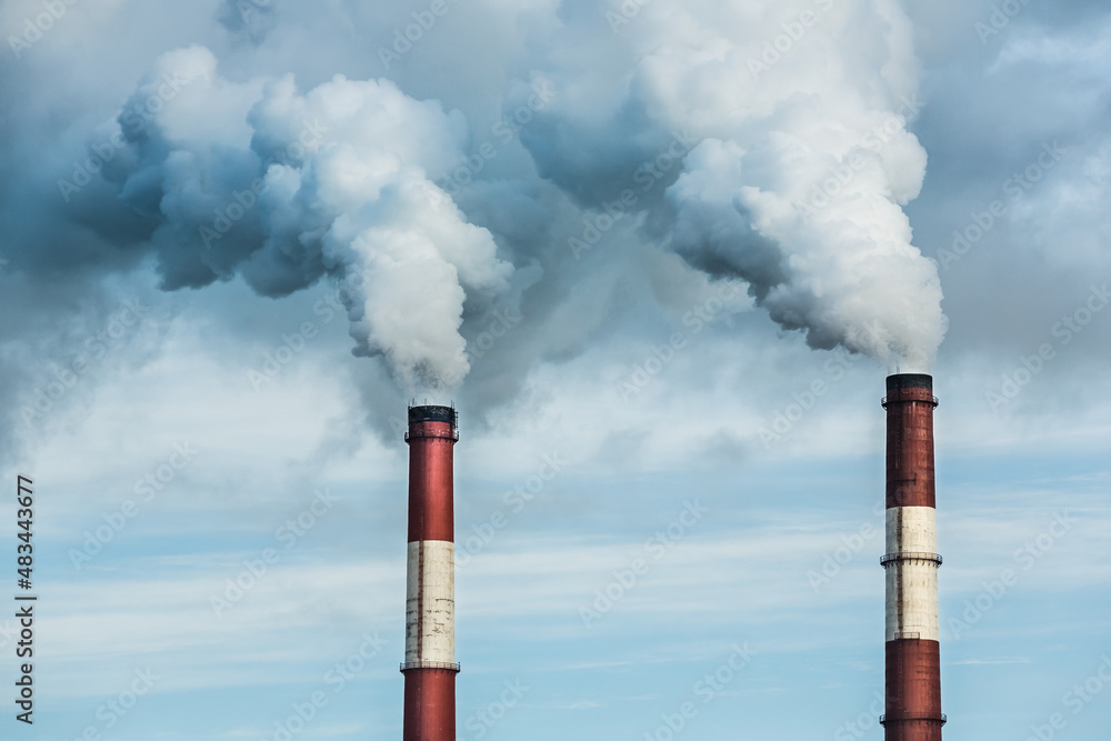 Closeup view steam coming out of pipes of thermoelectric power station in winter time.