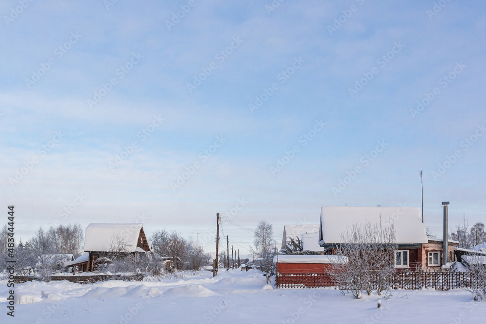 Street with private wooden houses in winter