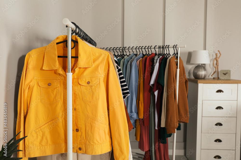 Racks with stylish clothes indoors. Fast fashion Racks with stylish clothes indoors. Fast fashion