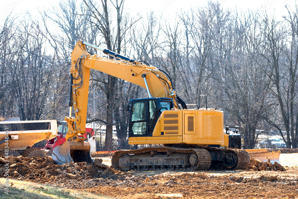 Excavator on a working platform yellow shovel Excavator on a working platform yellow shovel