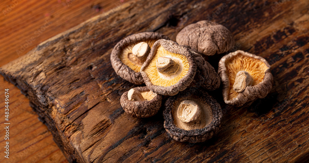 Dried shiitake mushrooms on a wooden background close up, banner for web site Dried shiitake mushrooms on a wooden background close up, banner for web site