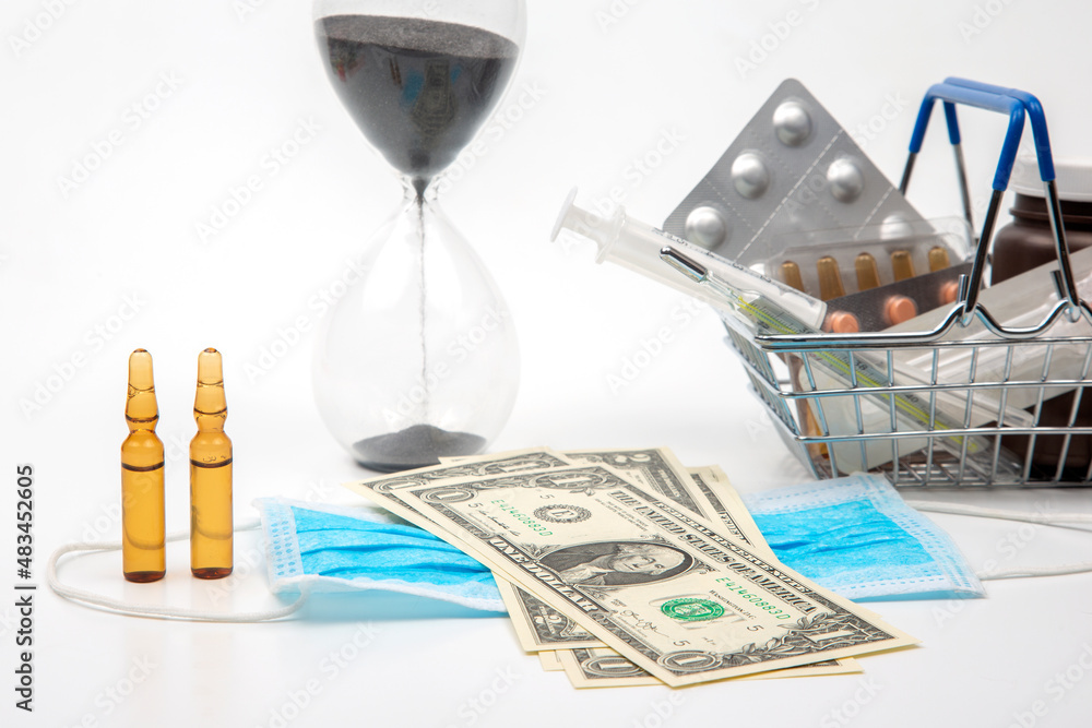 pills, ampoules and syringe for injection, money dollars and hourglass on a white background. business and medicine. pills, ampoules and syringe for injection, money dollars and hourglass on a white background. business and medicine.