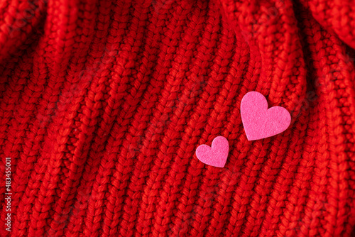 Decorative pink heart on a red knitted background  top view. Place for an inscription.