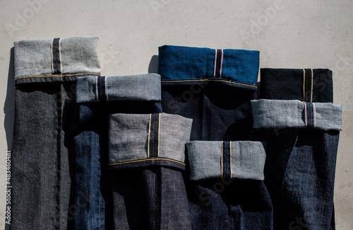 Obraz na płótnie Variety of denim on a gray background. Selvage denim. Denim background. Pants are blue. Close-up w salonie