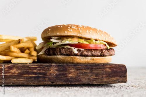 Close-up of homemade big tasty burger with fries