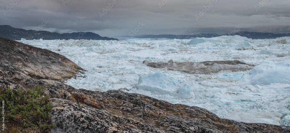 Panoramic image of the ilulissat icefjord in summer packed with ice and icebergs Panoramic image of the ilulissat icefjord in summer packed with ice and icebergs