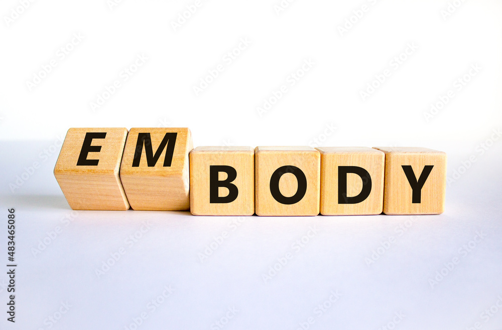 Body and embody symbol. Turned wooden cubes and changed the concept word body to embody. Beautiful white table, white background, copy space. Medical, body and embody concept. Body and embody symbol. Turned wooden cubes and changed the concept word body to embody. Beautiful white table, white background, copy space. Medical, body and embody concept.
