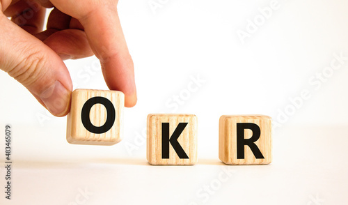 OKR, objectives and key results symbol. Concept words OKR objectives and key results on wooden cubes on a beautiful white background. Business OKR objectives and key results concept. Copy space.