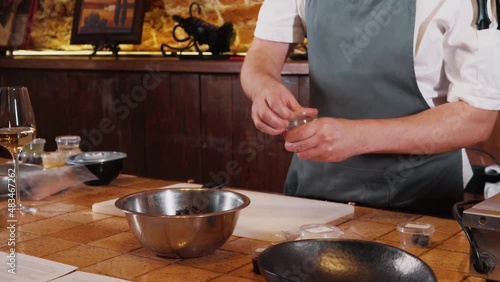 The chef on the stream prepares a dish of fried fish with broccoli and sauce