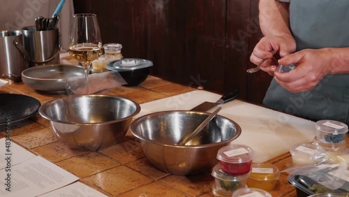 The chef on the stream prepares a dish of fried fish with broccoli and sauce