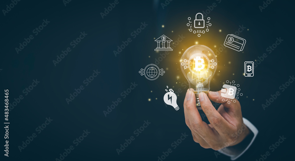 Businessman hand hold light bulb with bitcoin Cryptocurrency Investment and icons, trade, save and make a profit with interest, virtual financial chart diagram, Digital symbol of new virtual currency. Businessman hand hold light bulb with bitcoin Cryptocurrency Investment and icons, trade, save and make a profit with interest, virtual financial chart diagram, Digital symbol of new virtual currency.
