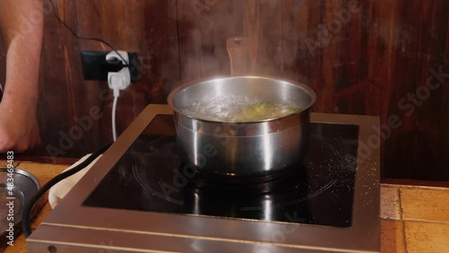 The chef on the stream prepares a dish of fried fish with broccoli and sauce