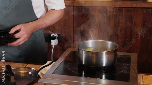 The chef on the stream prepares a dish of fried fish with broccoli and sauce