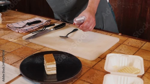 The chef on the stream prepares desserts with topping