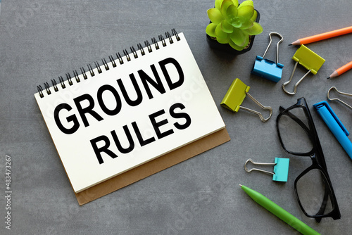 Fotografie ground rule open notepad with text on a gray background multi-colored stationery