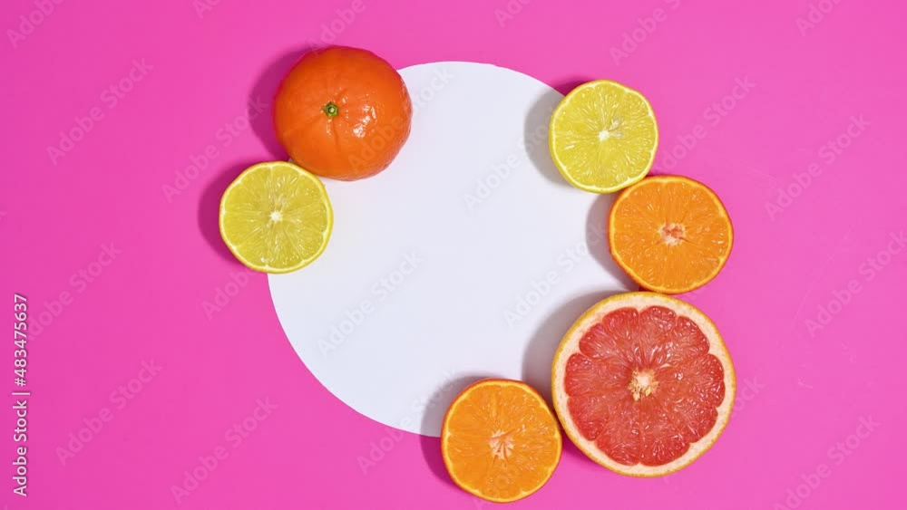 Half sliced ripe fresh citrus tropic fruits come around white paper for text. Stop motion flat lay Half sliced ripe fresh citrus tropic fruits come around white paper for text. Stop motion flat lay