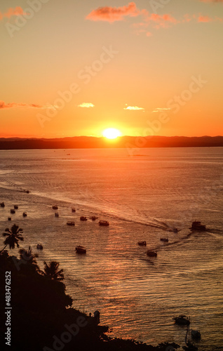 Aerial view of beautiful sunset above the sea with sail boats sailing on water. Sunset over the horizon