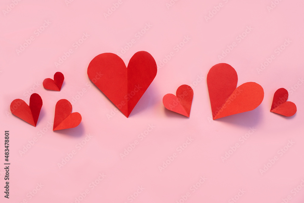 Valentines day paper hearts on pink background. View from above. Valentines Day Concept.