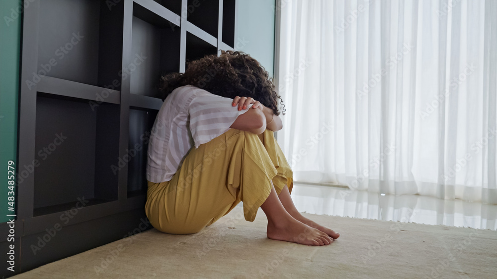 Latin woman sitting on floor feels unhappy by personal problems, break up or ruined marriage Latin woman sitting on floor feels unhappy by personal problems, break up or ruined marriage
