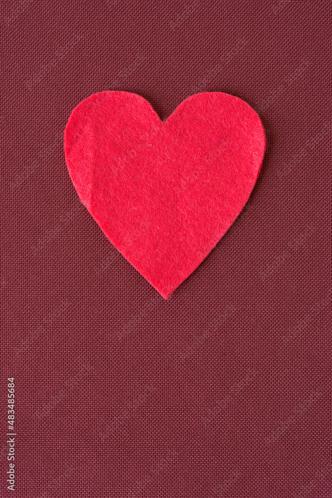 isolated felt heart on a fabric background isolated felt heart on a fabric background