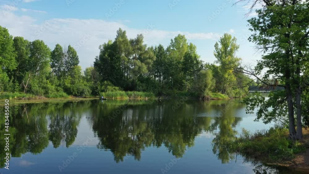 Flying over the calm summer lake in forest, sky reflection, 4k Flying over the calm summer lake in forest, sky reflection, 4k