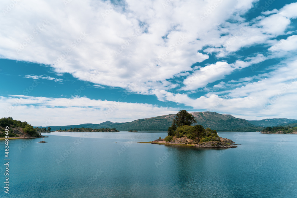 island in the lake with clouds 