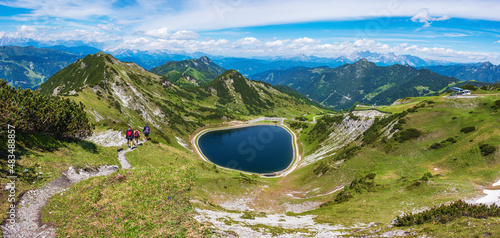 The panoramic view of blue alpine mountain lake Seekarsee lies at 2000 meters above sea level. High resolution panorama of a beautiful alpine summer wonderland at Flachau, Salzburg, Austria