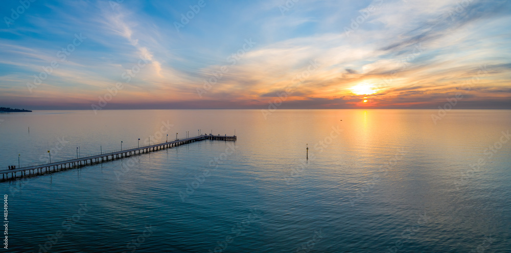 Aerial panorama of long wooden pier at beautiful sunset in Australia