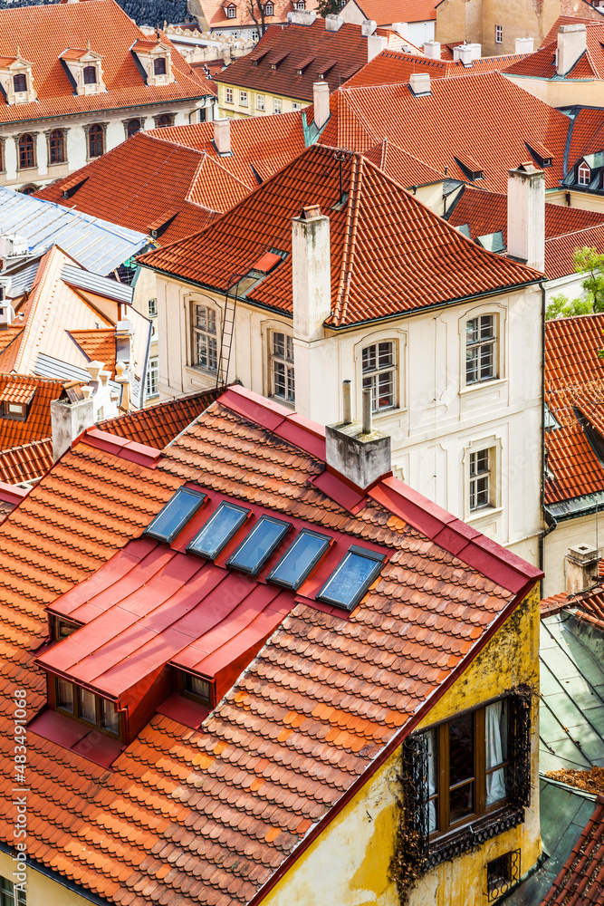 Old dwelling houses with red tiled roofs in Prague