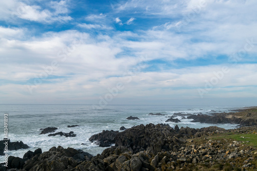 Beach view with ocean rocks on the coast © Vtor