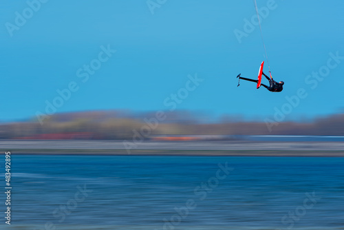 Kite surfer flying 10m (30f) high on a day with strong wind in the Netherlands.