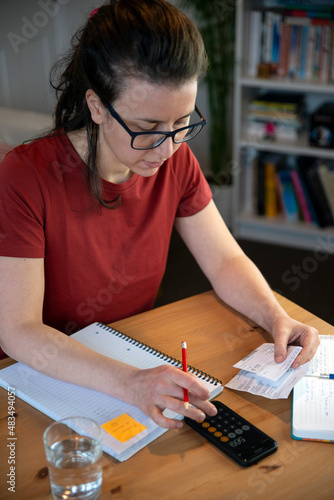 January 4th 2021: London, UK: Accountant doing paperwork in a home office