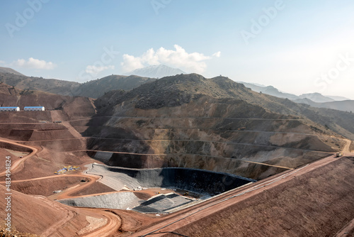 View of the tailings dam or waste dam construction and sealing membrane assembly for mining site.