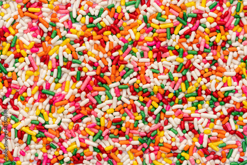 Top view of multicolor rainbow sprinkles. Colorful sprinkles sugar background. Sugar sprinkles is for decoration cake and other bakery items.