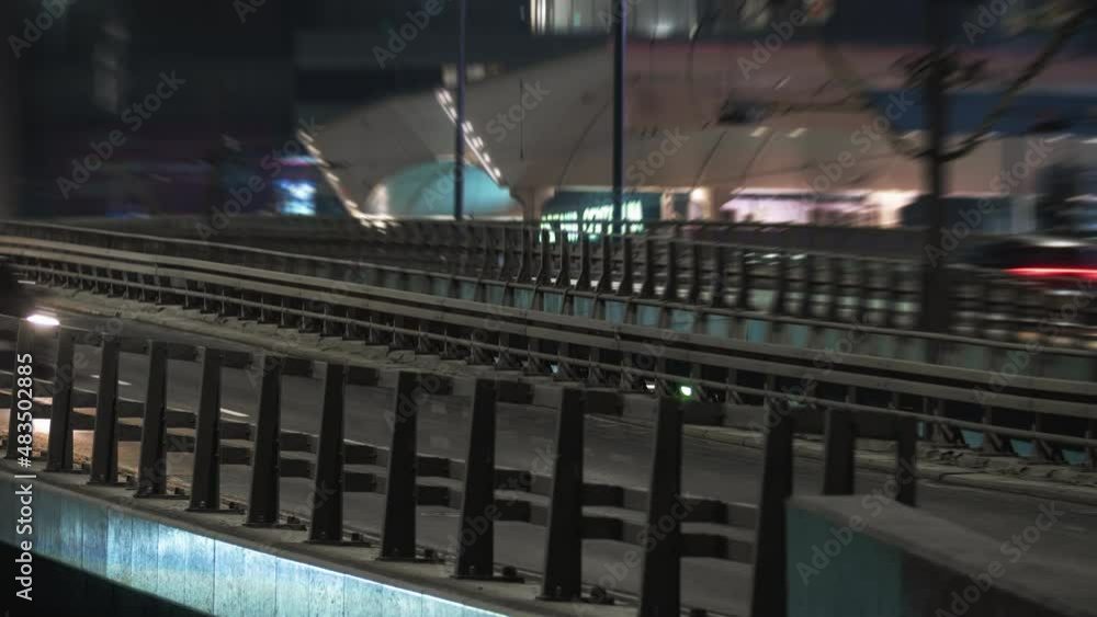 Close-up time lapse traffic jam interchange overpass road at night, intersection roadway in modern big city in evening. Timelapse town highway. Cars moving fast drive way, lights trails Close-up time lapse traffic jam interchange overpass road at night, intersection roadway in modern big city in evening. Timelapse town highway. Cars moving fast drive way, lights trails