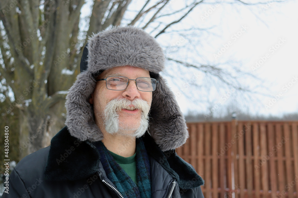 senior man in fur hat on winter day outside senior man in fur hat on winter day outside