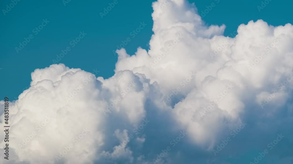 Timelapse of white puffy cumulus clouds forming on summer blue sky. Moving and changing cloudscape weather Timelapse of white puffy cumulus clouds forming on summer blue sky. Moving and changing cloudscape weather