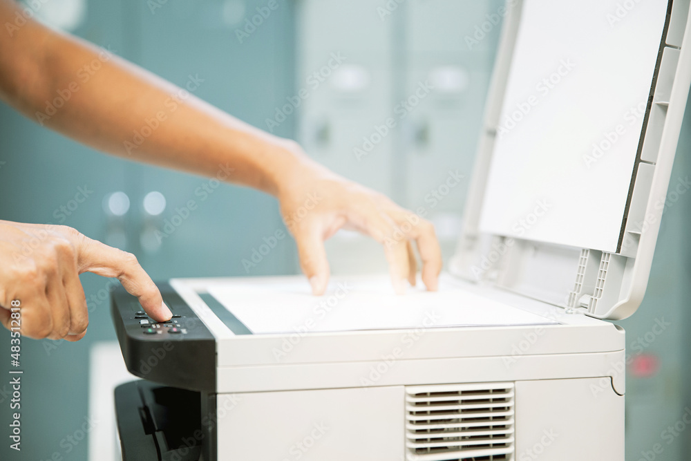 Copier printer, Close up hand office man press copy button on panel to using the copier or photocopier machine for scanning document printing a sheet paper and xerox photocopy. Copier printer, Close up hand office man press copy button on panel to using the copier or photocopier machine for scanning document printing a sheet paper and xerox photocopy.