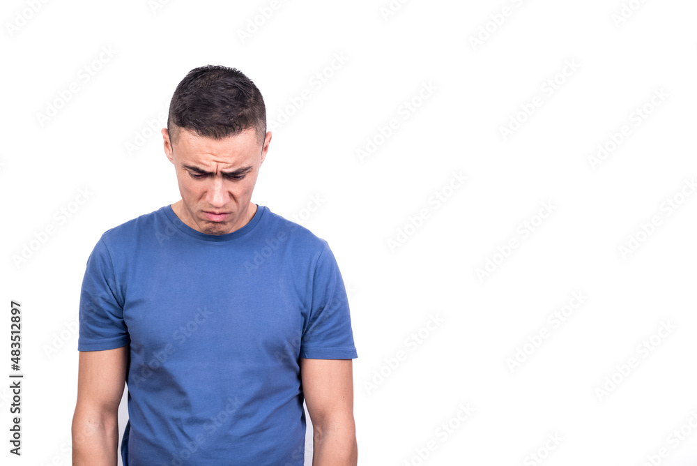 Man looking down while standing with sad expression Man looking down while standing with sad expression
