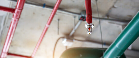 Close-up fire sprinkler on the ceiling for fire detection and alarm system equipment in building safety security protect and prevent or prevention when heat or flame detector is alert.