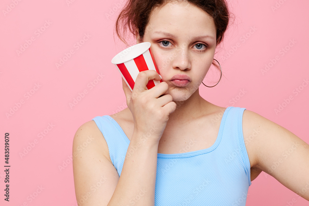 pretty woman with disposable glass posing emotions pink background unaltered pretty woman with disposable glass posing emotions pink background unaltered