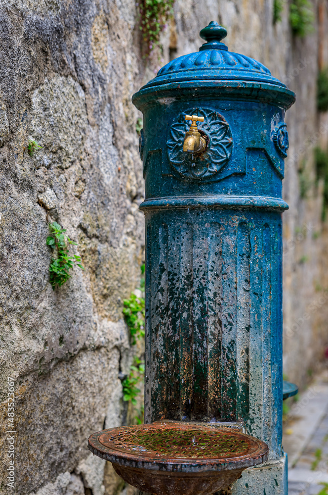 Antique water pump in a courtyard in Porto, Portugal Antique water pump in a courtyard in Porto, Portugal