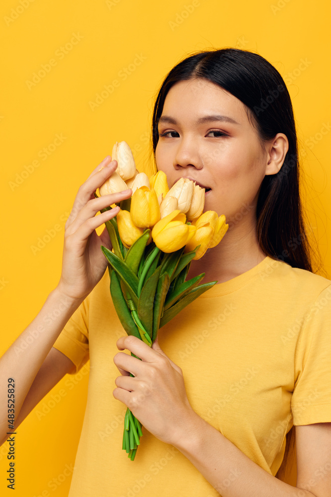 pretty brunette bouquet of flowers in hands spring fun posing yellow background unaltered pretty brunette bouquet of flowers in hands spring fun posing yellow background unaltered