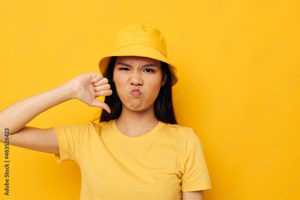 woman wearing a yellow hat posing emotions yellow background unaltered woman wearing a yellow hat posing emotions yellow background unaltered