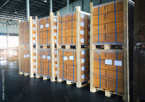 Stacked of Packaging Boxes Wrapped Plastic Film on Pallets in Storage Warehouse. Supply Chain. Storehouse Commerce Shipment. Shipping Warehouse Logistics.	

