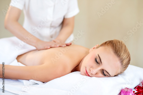 Beautiful happiness young attractive Caucasian woman having body massage by Thai Masseur in spa salon. Beauty treatment and body care lifestyle concept 